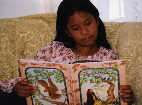 Girl reading The Old Woman and the Eagle