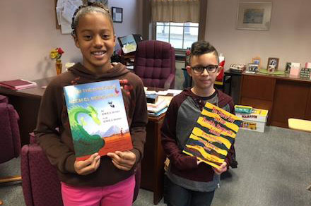 2 children with Hoopoe English-Spanish bilingual books