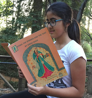 Teenager reading Fatima the Spinner and the Tent